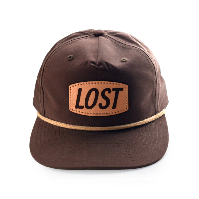 Brown cap with 'LOST' patch on a white background